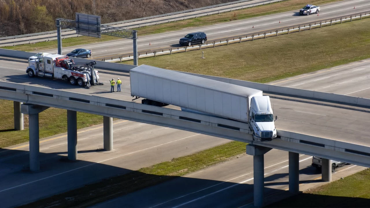 Two Injured After 18-Wheeler Hangs Over I-10 Overpass Near SH-99